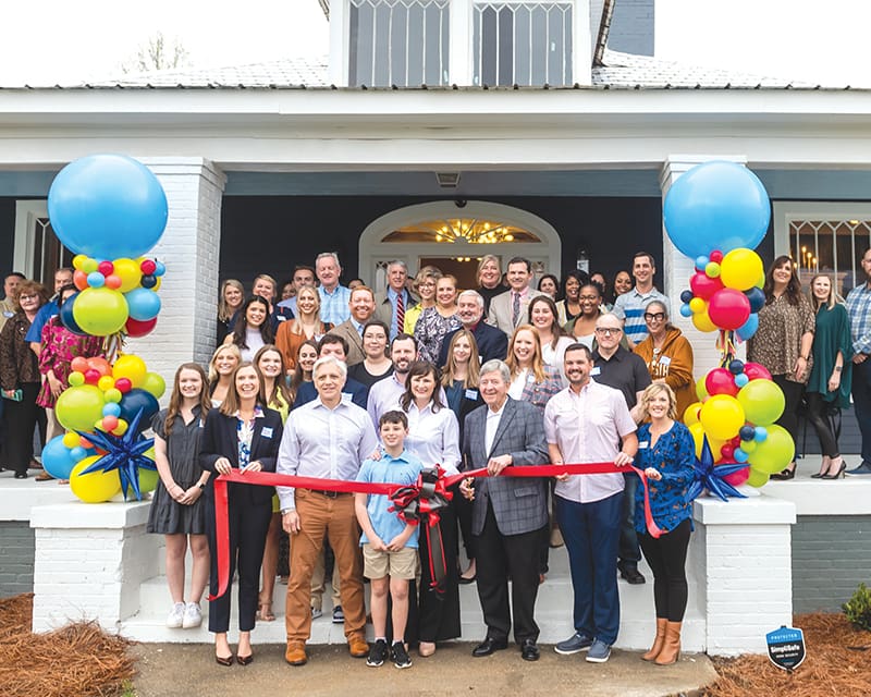 The Here Molly Girl team and local community members at the grand opening of the new office building in Opelika, AL